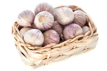 garlic in a basket isolated on white background