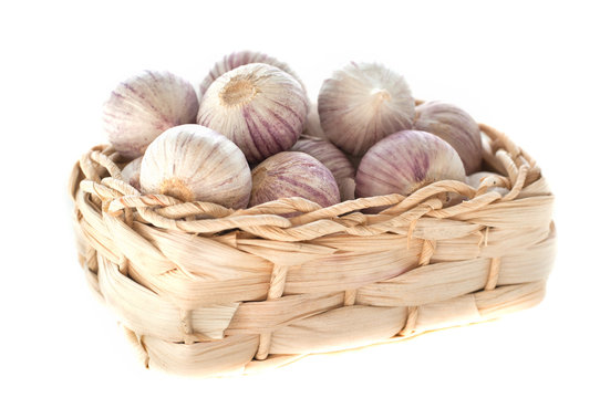 garlic in a basket isolated on white background