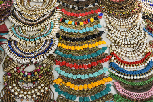 Many traditional antique Necklaces, Chains on a market in Jodhpur, India. Colourful handmade jewellery  using beads, metal, stones, thread worn by woman of Rajasthan arranged for sale on Indian street