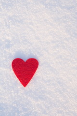 Red felt heart shape in snow, Valentine's Day. Copy space for text. Snowflakes on heart. Valentines day, love concept. White background
