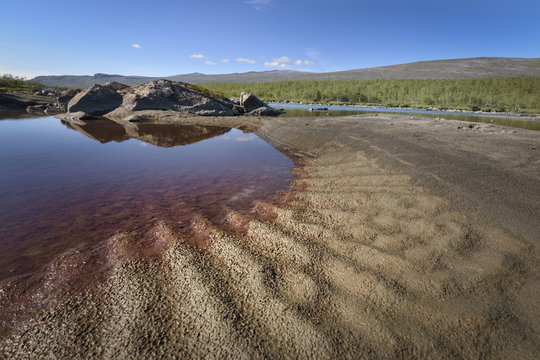 Red coloration in pool beside river due to iron, Sarek, Sweden