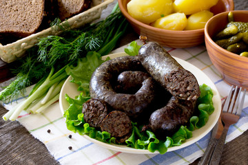 Homemade buckwheat liverwurst and sausage and boiled potatoes on