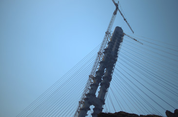 Construction of the cable-stayed bridge. Cable-stayed pylon in foreground