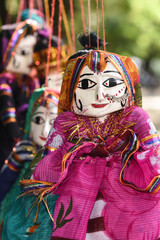 Hand made puppets attached to string in Rajasthan India dolls. Women face with traditional Indian...