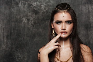 Obraz premium Amazing model looking at camera while touching face with hand.