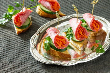 Holiday appetizer: Canapes on crispy bread with cucumber, carrot