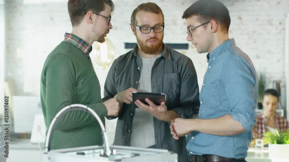 Poster three creative men discuss business matters passing tablet computer to each other. people work in ba