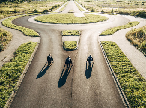 Three businessmen starting race at roundabout