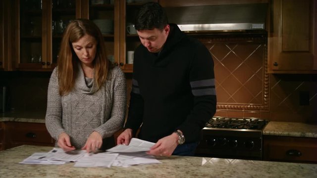 Husband and wife fighting about bills, their son wants to play