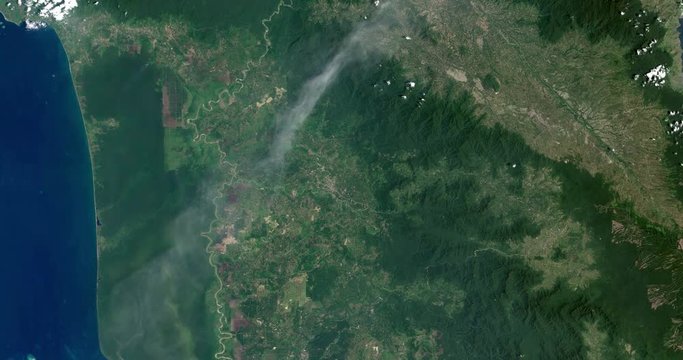 High-altitude overflight aerial of volcanic activity on Sinabung Volcano, Indonesia. Clip loops and is reversible. Elements of this image furnished by USGS/NASA Landsat
