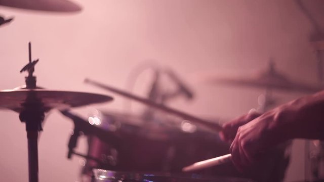 Concert rock band performing on stage. Drummer