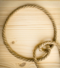 Round rope frame on a wooden background. Sea border.