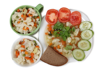 Porcelain plate with vegetable soup on white background