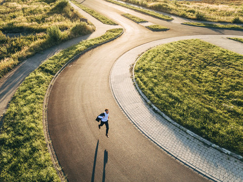 Businessman running in roundabout