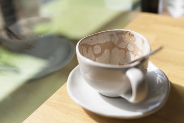 empty Hot cocoa in a white cup In a cafe on the table by the win