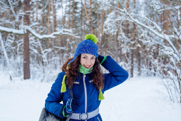 Fototapeta na wymiar young female enjoying winter in snowy park