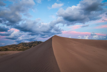 Untouched Sand Dune during a cloudy sunset 