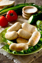 Homemade chicken sausage meat and various vegetables, herbs on r