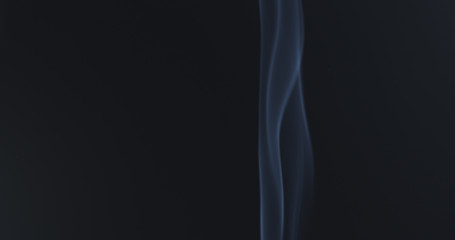 mystery blue smoke over dark background with copy space