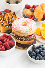 glazed donuts, sweets and fresh berries, vertical