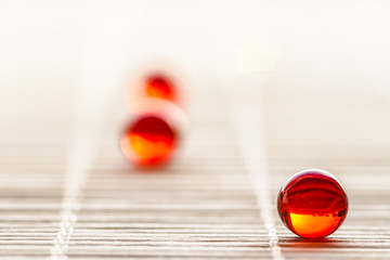 Vitamin E capsules isolated on wood background