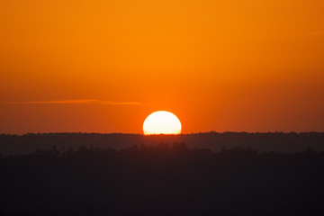 silhouette yellow half sunset orange sky and moutain