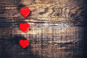 Valentine's Day Card with red hearts on wooden background with