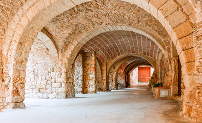 Medieval arched street in the old town of Pertallada, Catalonia, Spain. 