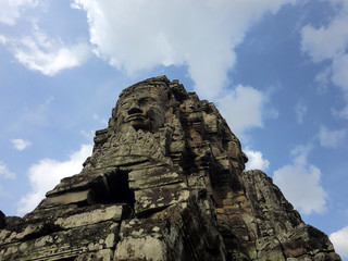 Fototapeta premium Bayon temple with carved stone faces in Siem Reap Cambodia jungle