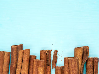 cinnamon sticks on blue with copy space