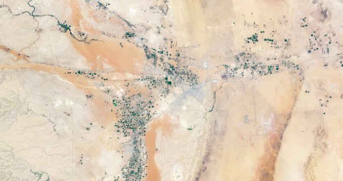 High-altitude overflight aerial of Todhia Arable Farm and surrounding land, Saudi Arabia. Clip loops and is reversible. Elements of this image furnished by USGS/NASA Landsat