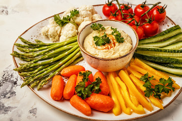 Healthy homemade hummus with assorted fresh vegetables.