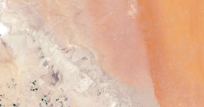 High-altitude overflight aerial of Todhia Arable Farm and surrounding land, Saudi Arabia. Clip loops and is reversible. Elements of this image furnished by USGS/NASA Landsat
