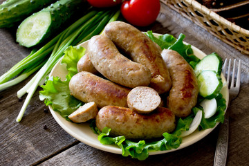Homemade meat smoked sausage and a variety of vegetables, herbs