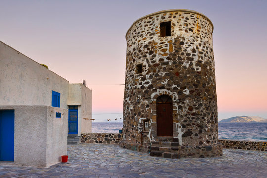 Windmill in Mandraki village and island of Giali in the distance.