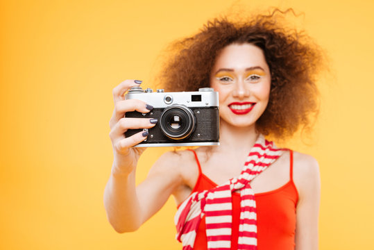 Smiling Bright model making photo on retro camera