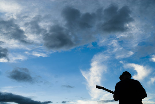Guitarist silhouette at blue sky in Brazil