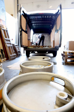 Worker in brewery, preparing to distribute barrels of beer
