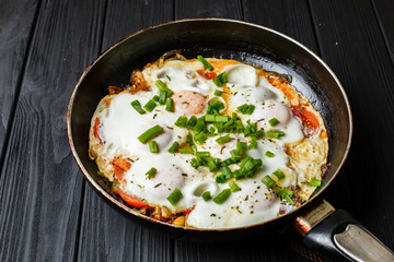 Breakfast on the wood table: a fried egg in frying pan