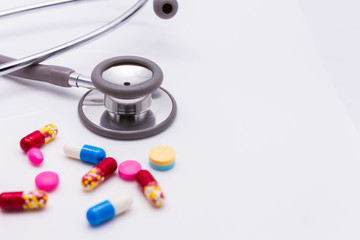 Doctor's stethoscope and pills closeup