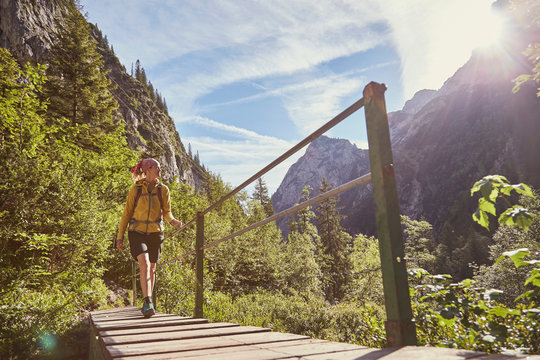 Woman walking across bridge, H&iacute;_llental, Zugspitze, Garmisch-Partenkirchen, Bavaria, Germany