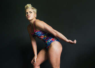 Fototapeta na wymiar photo athletic girl posing in a swimsuit gray background