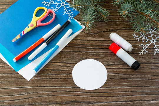 Glue, paper, scissors on a wooden table for a toy on the Christm