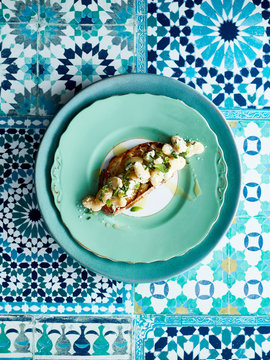 Broad beans on slice of baguette