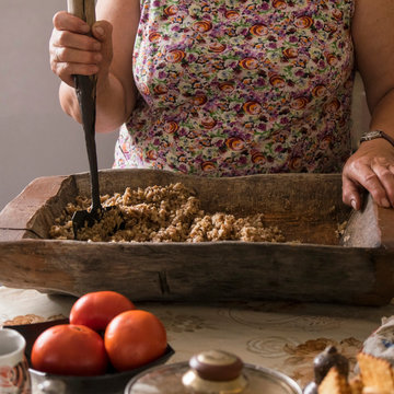 Cropped view of woman chopping food in wooden chopping board, Ural, Russia