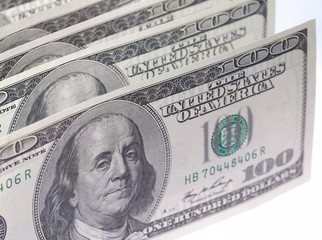 One hundred dollar bills in U.S. currency on white background.
