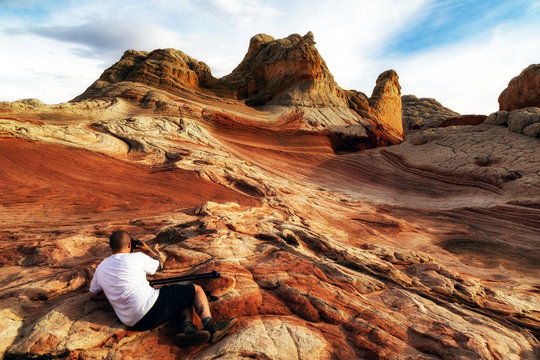 Photographer photographing White Pocket rock formation, Page, Arizona, USA