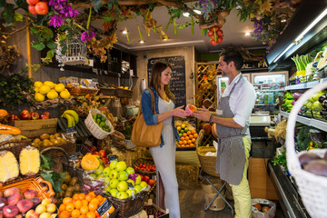 Fruiterer serving customer in shop, Palma de Mallorca, Spain