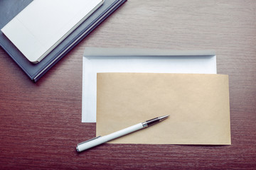 Photo of blank envelope on a  wooden background