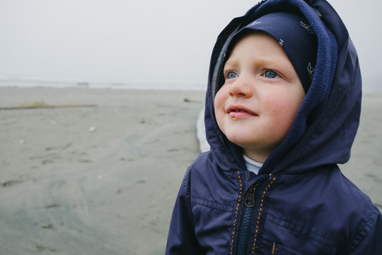 Young boy standing on beach, Long Beach, Vancouver Island, British Columbia, Canada